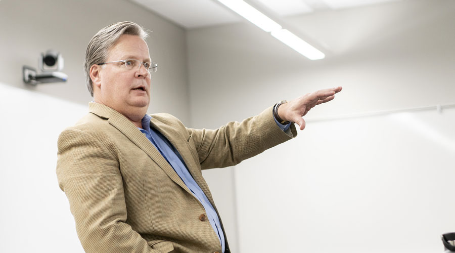 Cory Erickson at the front of a class teaching